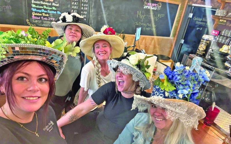 A group of local ladies wore their best Kentucky Derby hats at the Golden Block Brewery as they watched the horse race. Photo credit Golden Block Brewery FB