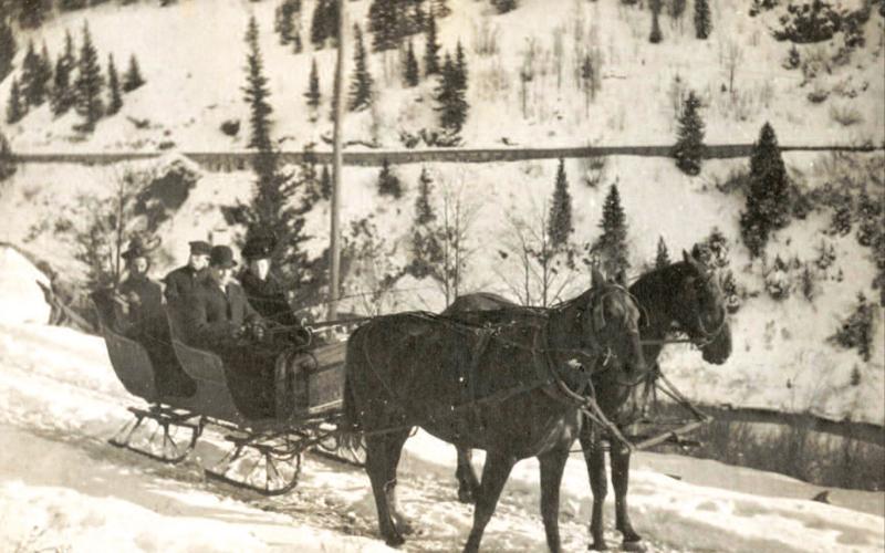 Enjoying a sleigh ride behind a two-horse team on Christmas Day, 1906, were, from left, Alice Dyson, James Dyson, Dan McNaughton and Edith Dyson McNaughton (she and Dan were married Oct. 19, 1906). The photo was probably taken on the Howardsville road above Arastra Gulch, based on the flume in the background. Photo Courtesy of the Edith Dyson McNaughton Archive