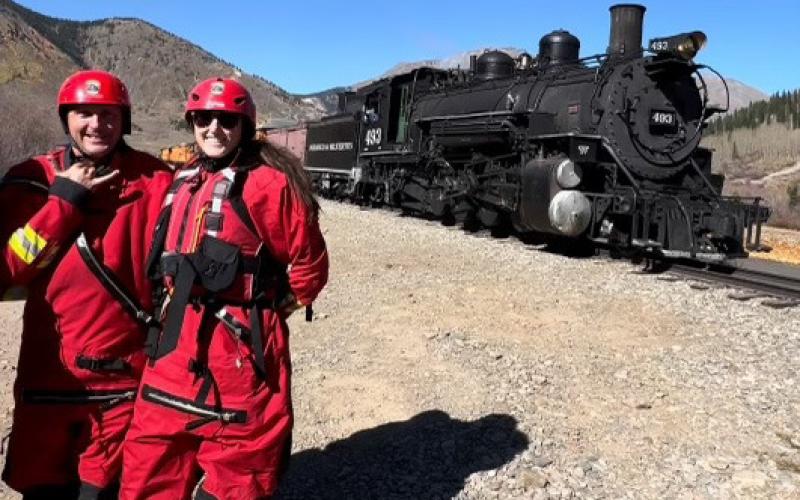 Swift Water Rescue students pose as DSNGRR passes by their outdoor classroom. Photo credit DeAnne Gallegos