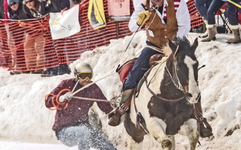 Skier and cowboy racing down Blair Street. Photo from Silverton Skijoring Facebook Page