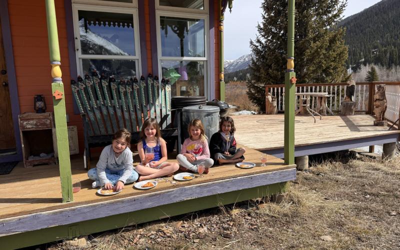 Mountain kids don't care! Despite the chilly wind in Silverton, Rainne Rajic, Ruby Copenhagen, Willow Blankenship, and Ava Andrade enjoy their lunch dressed for spring Photo by Katey Fetch