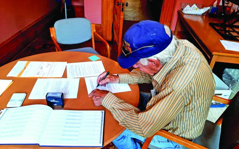 There is one photo of George Zanoni (with the hat on) signing the document. Photo Credit Town of Silverton