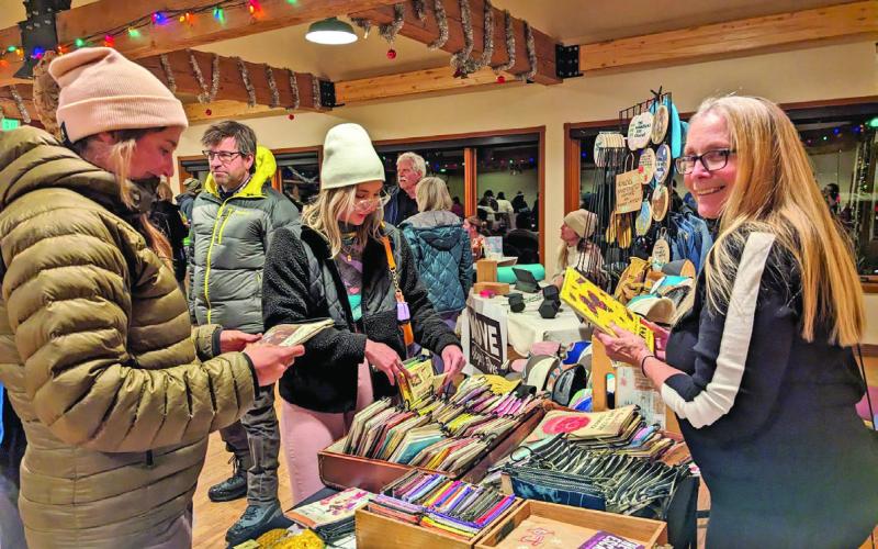 Kathy Laskey selling at the Creative District’s Mistletoe Market in 2023 Photo credit Cracked Compass Photography