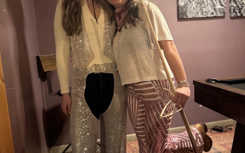 Sarah Moore and Lucy Mulvihill both dressed up as sparkly cowgirls for the skijor party at The Den photo by DeAnne Gallegos