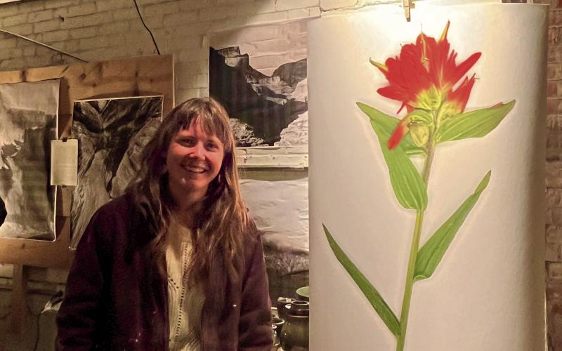 Hannah Green standing next to her artwork. Photo by DeAnne Gallegos