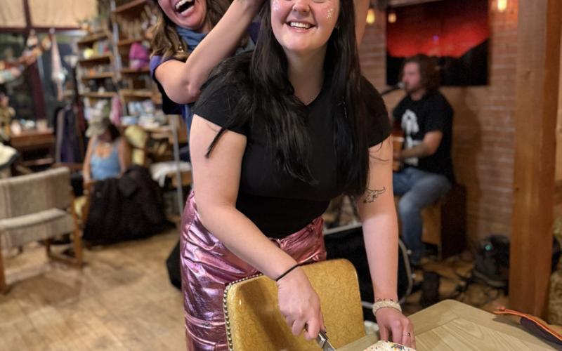 Holly Huebner sharing her little sister Zoe’s 23rd Birthday with a fun cake photo by DeAnne Gallegos