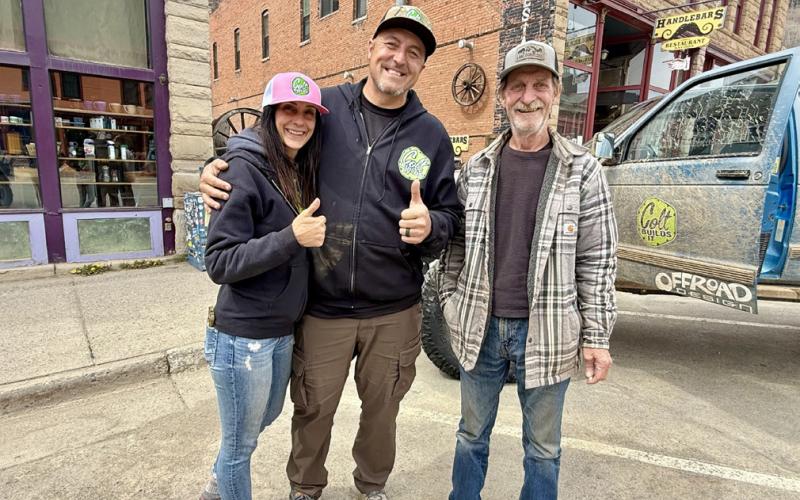 Shanna and Colt take a photo with fan Dan Haupert after Dan spots the YouTube influencer Colt Builds It in downtown Silverton photo by Susan Haupert