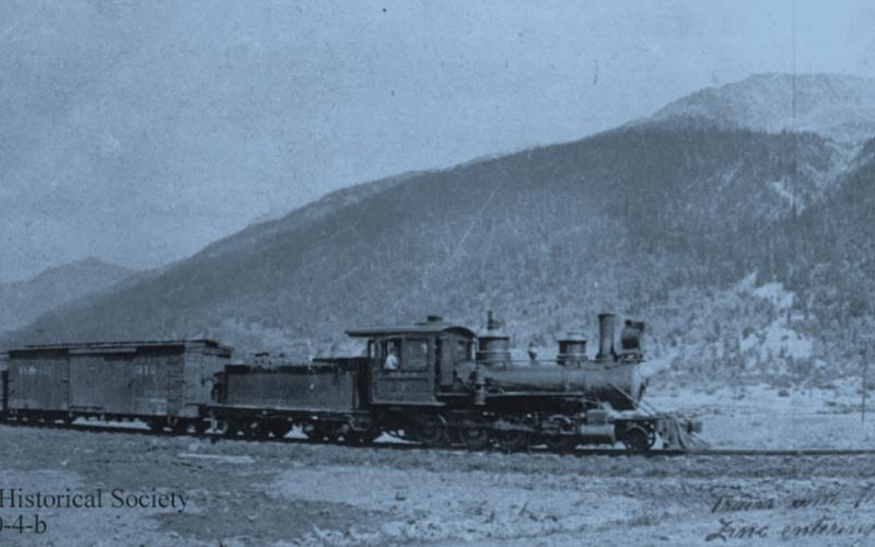 A Silverton Northern Railroad train hauls 10 carloads of zinc concentrates into Silverton, around 1925, pulled by SN #4, with two men on the third boxcar. San Juan County Historical Society photo