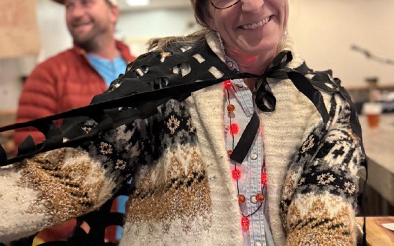 Anne Izard wears a bat wing while out enjoying Halloween. Photo by DeAnne Gallegos