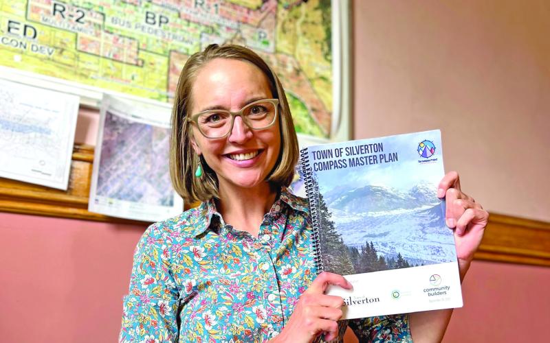 Town Administrator Gloria Kaasch-Buerger holds up the Town of Silverton’s Compass Master Plan. Photo credit DeAnne Gallegos