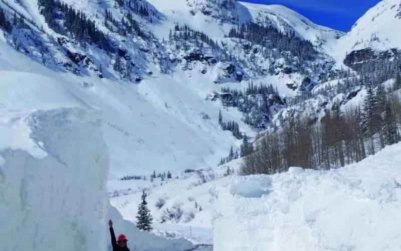 Lisa Schwantes Communications Manager for CDOT next to massive slide Photo by CDOT