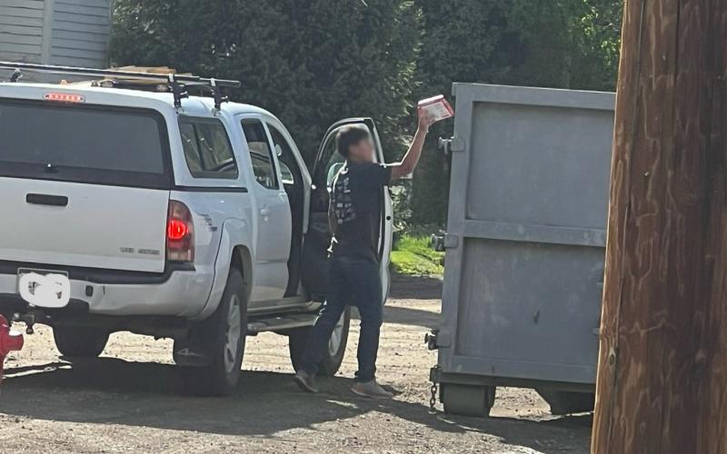 While counting and assessing trash cans, a traveler emptied trash from their truck into an open construction dumpster on 11th and Greene if you place them out, people will get rid of their trash when they can. Photo credit DeAnne Gallegos