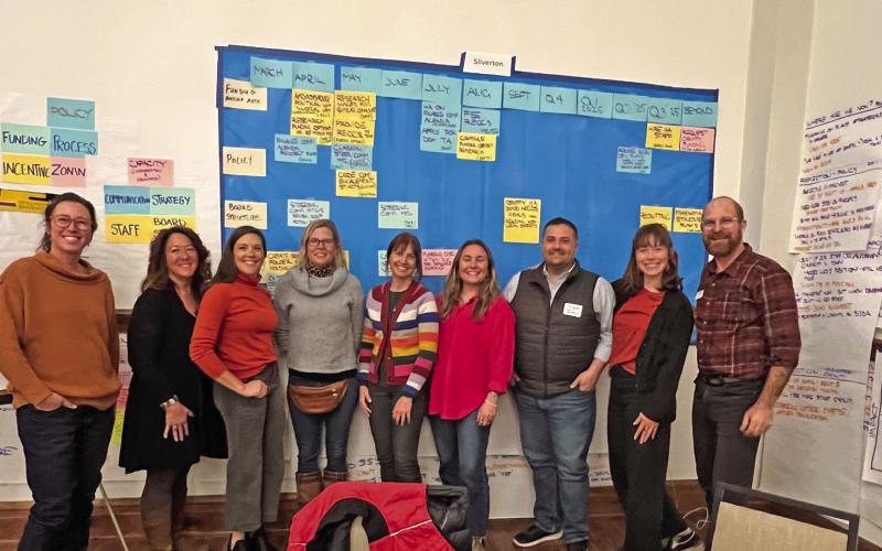 (L to R) Sara Mordecai, DeAnne Gallegos, Dayna Kranker, Melissa Childs, Emily Thorn, Lucy Mulvihill, Jim Harper, Anne Chase, JJ Folsom. Photo credit DeAnne Gallegos