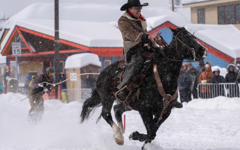 Racing down snow laden streets caused more obstacles for horse and riders.. Photo credit Wesley Berg All print and digital downloads of skijoring photos provided by Wesley Berg are available for purchase at www. wesleybergphotography under the events tab.