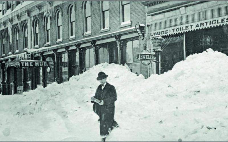 Good day, Sir. A nicely dressed, but unknown man walks through an apparent cut in the snowbank on Greene Street in front of the Grand Hotel, left, and Cunningham &amp; Crocker Drugstore, right. The sign for the Hub Saloon can be seen. What debauchery happened there? The photo comes from the archives and is believed to have been taken in 1906. Photo: Archival photo from the San Juan County Historical Society