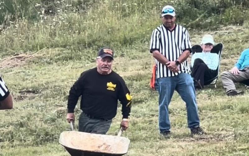 Terry Rhoades competing in the wheelbarrow race. Photo credit DeAnne Gallegos