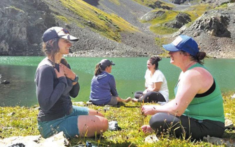 Women connecting at a glacier lake during the Silverton, CO New Moon Hike