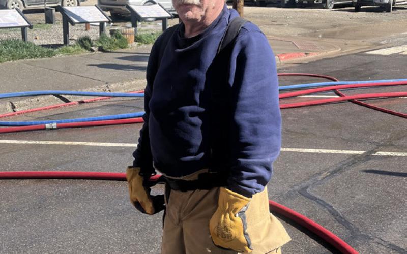 Dave Zanoni, of the Silverton Volunteer Fire Department, helping to keep the streets of Silverton clean photo by Scott Fetchenhier