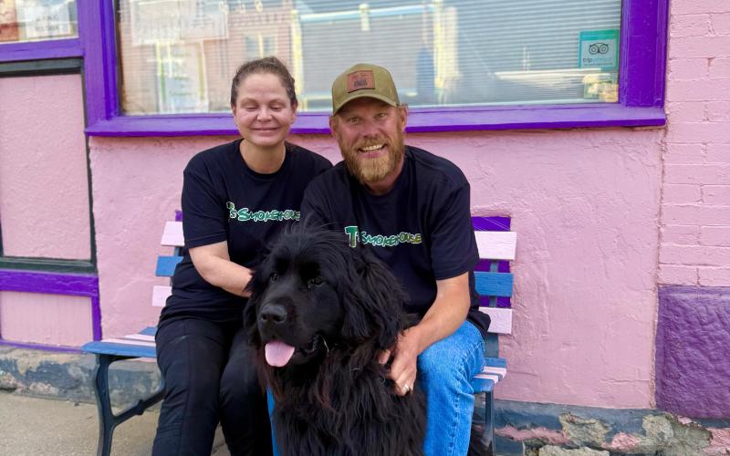 Sherrie &amp; Chris Martin sit out front of T’s Smokehouse after a busy day with their dog Nola. Photo by DeAnne Gallegos