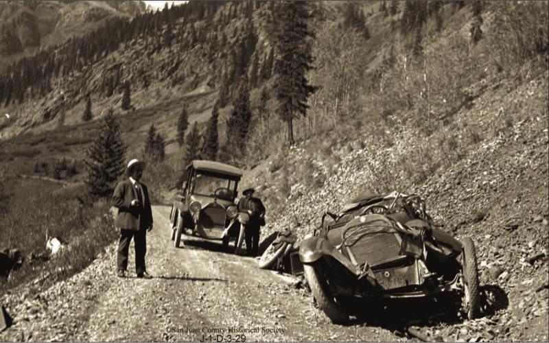 The wreckage of Will Ennis’ automobile on the roadway above Chattanooga. Two men are on the roadway. The man at right is Fred Patterson. The Ennis vehicle crashed on Wednesday, Oct. 5, 1921 Photo courtesy of San Juan County Historical Society
