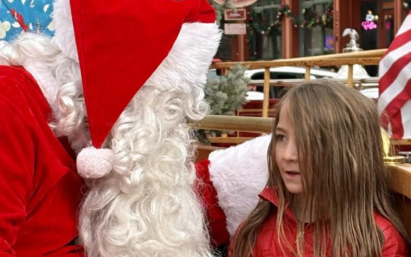 photo by Anne Izard Silverton Kid Talon Pinto tells Santa Claus about the new dirt bike he would like for Christmas