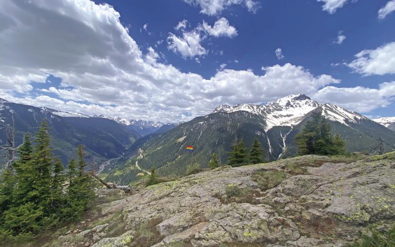 A pride flag on a summit above town. Photo by Blair Tice