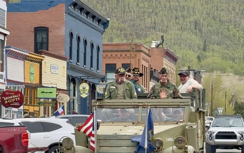 Local veterans ride the vintage halftrack down Greene St on Memorial Day photo by DeAnne Gallegos