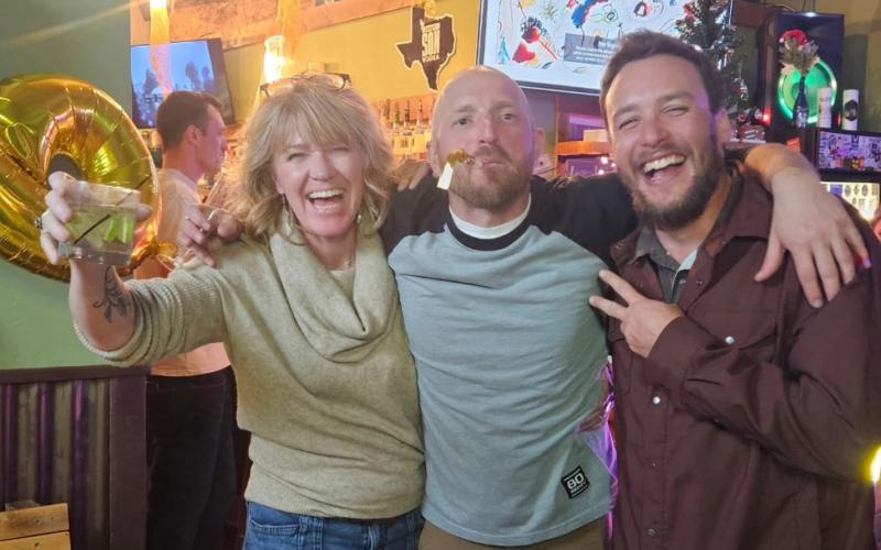 Silverton Locals Cara, Michael, and Marshal celebrate midnight at the Alpine Tavern New Year's Party photo by Shiloh Sams