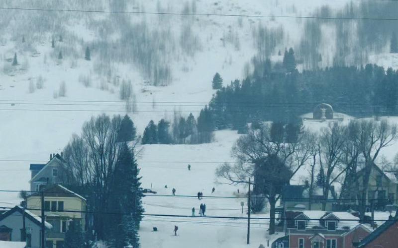 Locals playing on the road below Shrine Hill during the snowstorm. Photo credit DeAnne Gallegos