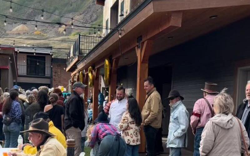 Local crowd mingling at community party.