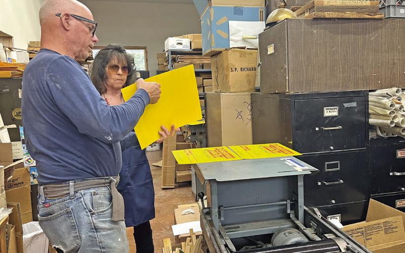 Judy Kuhlman and Tom Lanis work on the printing of the Hardrockers Holiday 50th Anniversary posters Photo credit DeAnne Gallegos