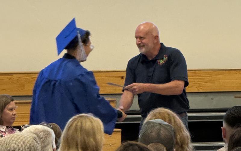 SSJVFD member Jerry Chambers presents graduate with a scholarship from the fire department photo by DeAnne Gallegos