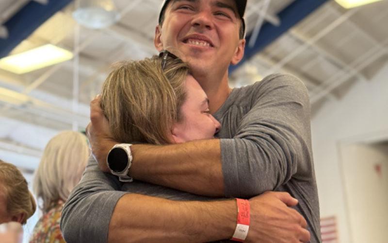 A Hardrocker hugs his wife at the all runners meeting the day before Hardrock start Photo by DeAnne Gallegos