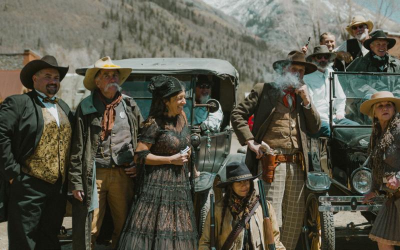 Locals line up by the two Model T’s for photos photo by Critt Kuenning