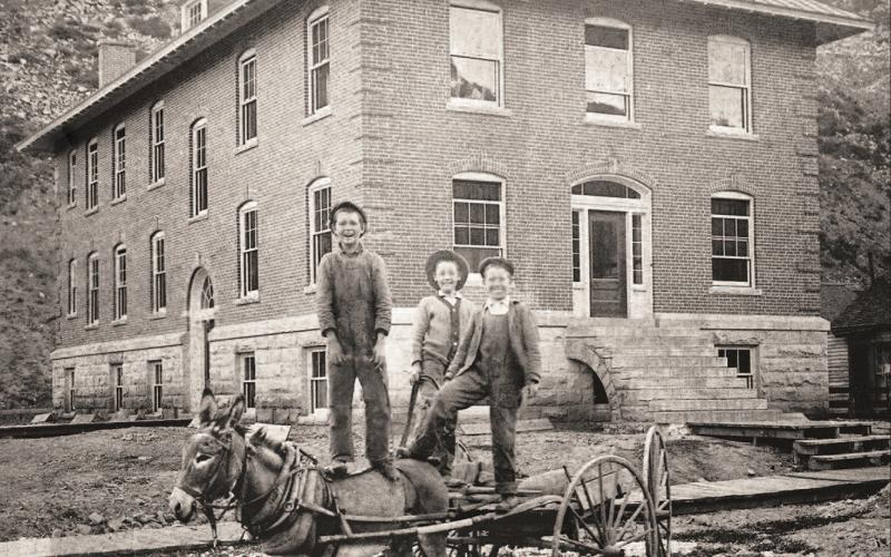 Three boys stand on a light wagon pulled by a burro in front of the Miners Union Hospital, 1315 Snowden Street, probably in 1912. From left are Myron Henry, Bill Gearry and Arthur Dreyer. The hospital building was only five years old at the time. Later this year its exterior will be restored in a $370,000 project funded by the State Historic Fund and the Department of Local Affairs. Photo courtesy of San Juan County Historical Society