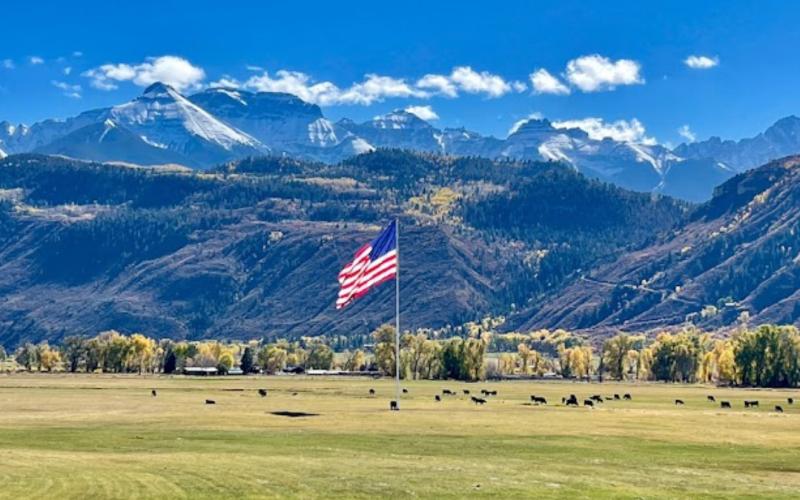 Weber Cattle Ranch located off of Hwy 550 has the large iconic American flag in the middle of the cattle pasture photo by Richard Weber