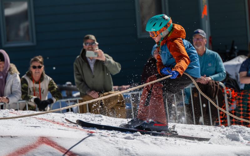 A junior racer skis up a Blair Street jump. Photo by Wesley Berg