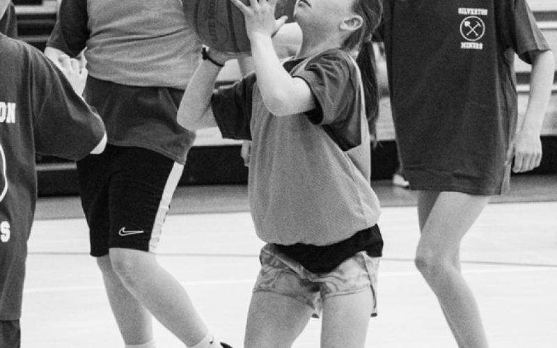 Photo credit Dave Emory Barrett Anderson and Monica Watton attempt to guard Lucas Barszcz in the adult vs. middle school game. Photo credit Dave Emory Betsey Barney sets up for a shot.