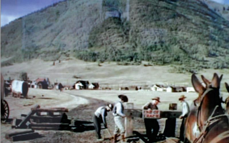 In this image from the movie “A Ticket to Tomahawk” railroad workers remove the “End of Track” sign as a 20-mule team begins to pull the Emma Sweeney locomotive out of Epitaph, Colo., to Tomahawk. The scene was shot in the summer of 1949, where the old Silverton, Gladstone &amp; Northerly Railroad split from the Denver &amp; Rio Grand tracks, near the present intersection of Cement and 12th streets.