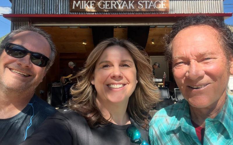 Derek Lee, Linda Cobb and Mike Geryak in front of the Mike Geryak Stage on Blair Street Photo by Linda Cobbz