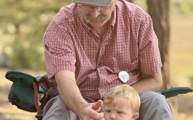 Scott Fetchenhier at Megan’s memorial on Sunday with his grand baby Rudie Jean photo by DeAnne Gallegos