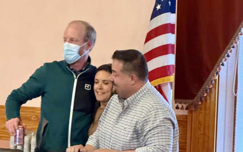photo by DeAnne Gallegos Former Town of Silverton Mayor Dayna Kranker gave former Trustee Tyler George and Pro-Tem Mayor Jim Harper a group hug