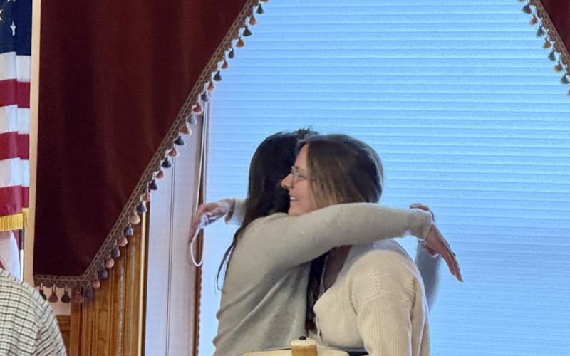 photo by DeAnne Gallegos Trustee Lindsey Halvorson and former Trusee Amie Gardiner hug goodbye