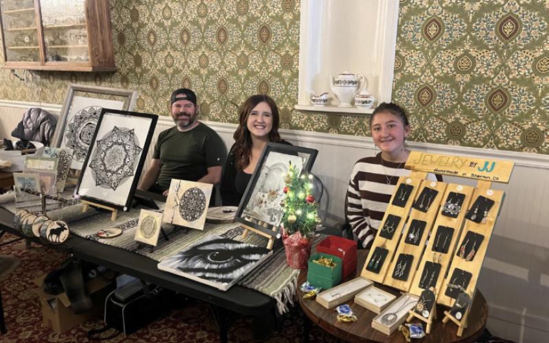 Patrick &amp; Haley Jones and her daughter Jayden, work their art booth photo by Haley Jones