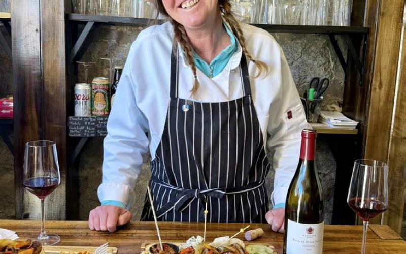 Wendy Polly shows the charcuterie board and gourmet sausages and bratwurst that they offer at The Osteria photo by The Osteria