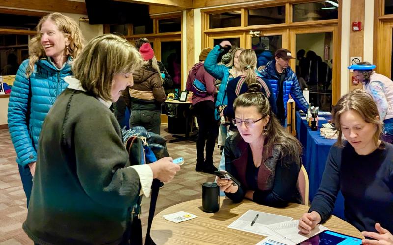 Becky Joyce and Tiffany DeKay check in at the MountainFilm event, and volunteers Lindsey Halvorson and Ella Bump take the tickets photo by Silverton Creative District