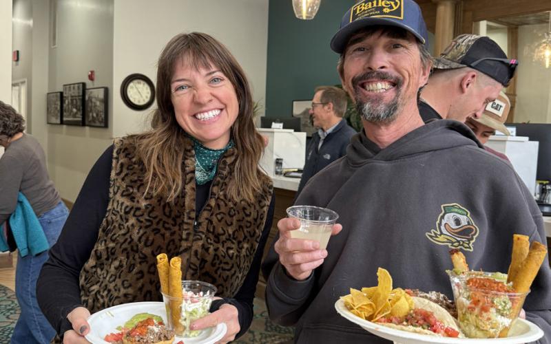 Holly Huebner and Paul Joyce enjoy local food truck High Altitude's tacos at the Citizens State Bank grand reopening party photo by DeAnne Gallegos