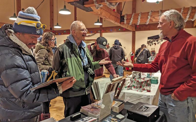 Photographer Wesley Berg’s table at the Mistletoe Market. Photo credit Silverton Creative District