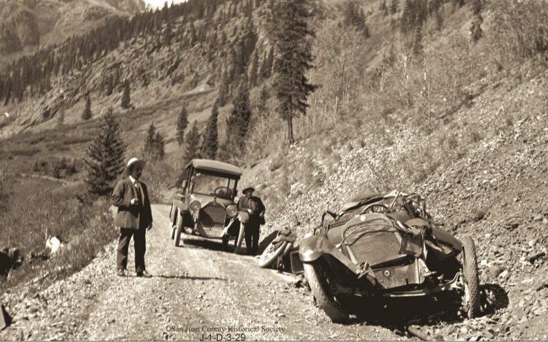 The wreckage of Will Ennis’ automobile on the roadway above Chattanooga. Two men are on the roadway. The man at right is Fred Patterson. The Ennis vehicle crashed on Wednesday, Oct. 5, 1921. Photo courtesy of San Juan County Historical Society