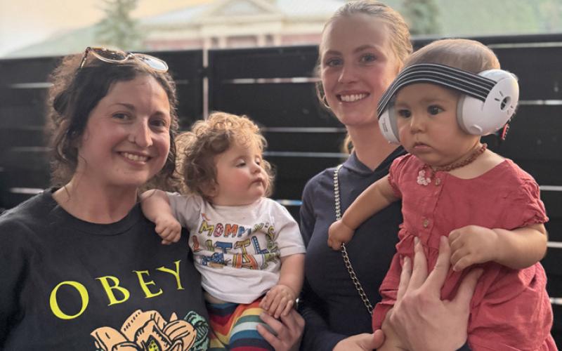 Photo by DeAnne Gallegos Friends Bekah Goll &amp; baby Odin and Meah Mordeci &amp; baby Katrina hang out in the family friendly Wyman Courtyard listening to live music together.
